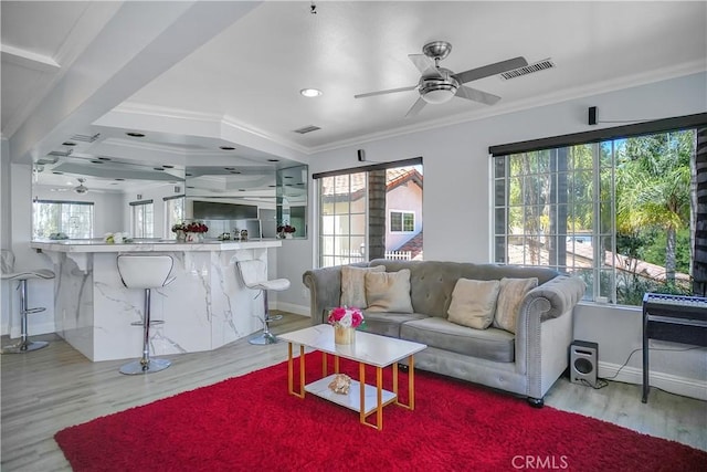 living area with ceiling fan, wood finished floors, baseboards, ornamental molding, and recessed lighting