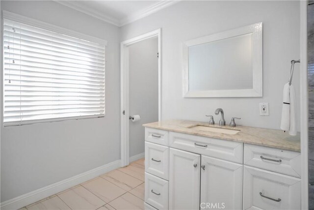 bathroom featuring ornamental molding, vanity, and baseboards