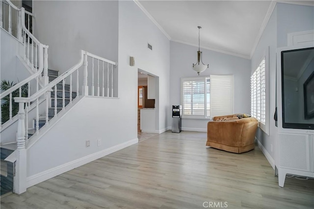 entryway featuring ornamental molding, stairs, wood finished floors, high vaulted ceiling, and baseboards