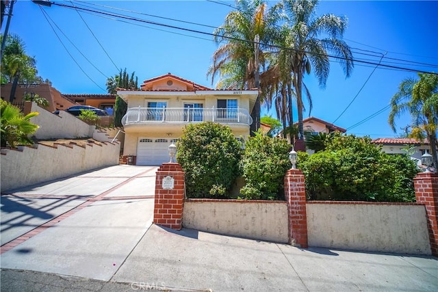 20171 Corona St, Corona, CA 92881 - mediterranean / spanish-style house featuring concrete driveway, stucco siding, an attached garage, and a balcony