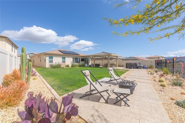 41215 Alegria Ln, Lake Elsinore, CA 92532 - rear view of house with a fire pit, a hot tub, roof mounted solar panels, a patio area, and a residential view
