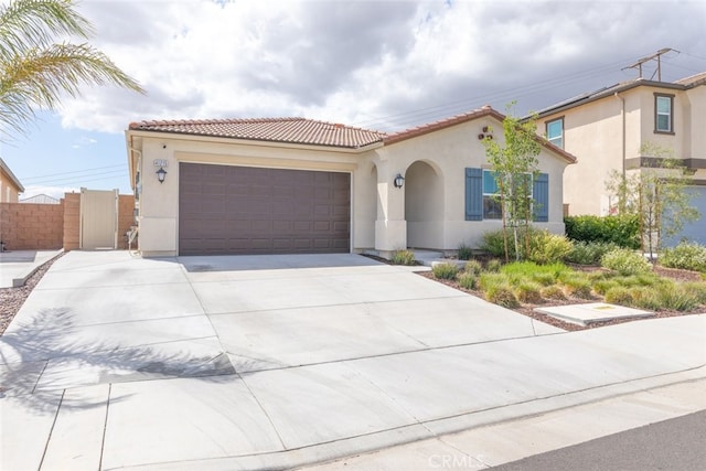 41215 Alegria Ln, Lake Elsinore, CA 92532 - mediterranean / spanish-style home with stucco siding, driveway, an attached garage, a tiled roof, and a gate