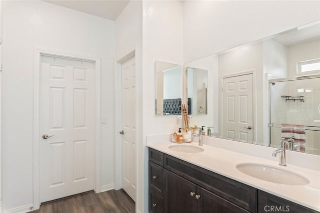 41215 Alegria Ln, Lake Elsinore, CA 92532 - bathroom featuring a stall shower, wood finished floors, and double vanity