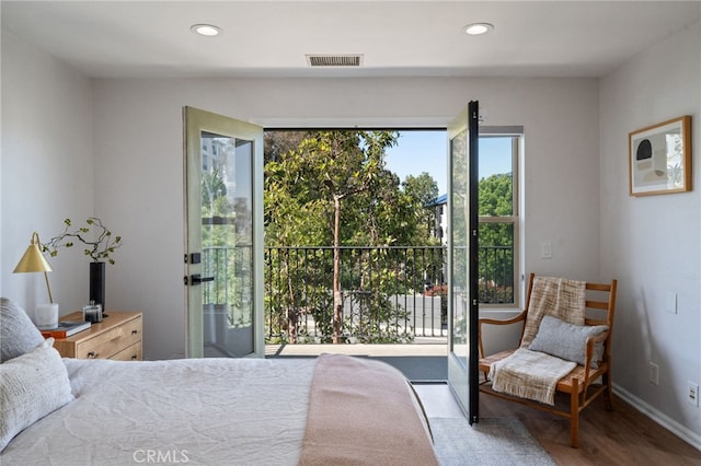 bedroom featuring wood finished floors, recessed lighting, and baseboards