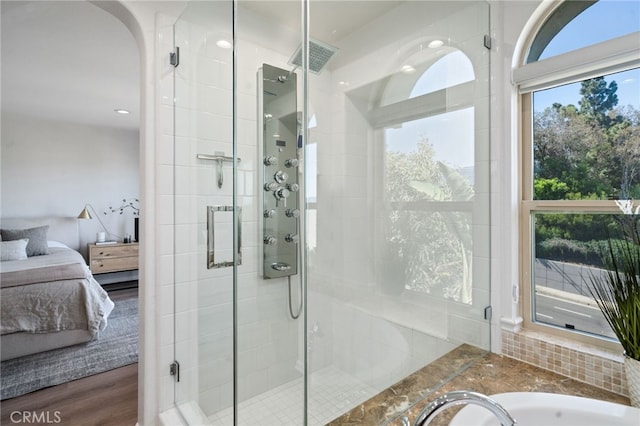 ensuite bathroom featuring a shower stall and a sink