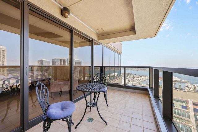 balcony featuring a water view and a view of city