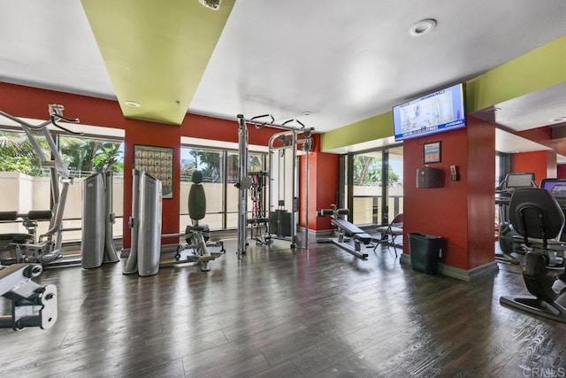 gym with wood finished floors, baseboards, and recessed lighting