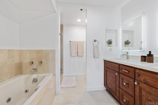 full bath featuring a whirlpool tub, tile patterned floors, double vanity, a shower stall, and baseboards