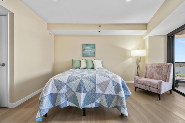 bedroom featuring baseboards and light wood-type flooring