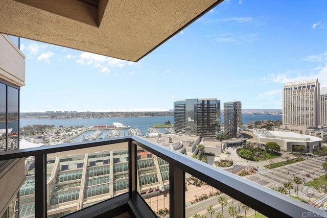 balcony featuring a water view, a city view, and view of marina