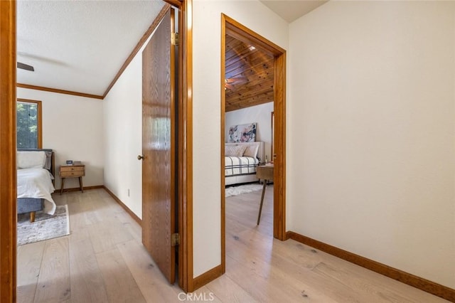 2604 Veneman Ave, Modesto, CA 95356 - corridor with light wood finished floors, baseboards, vaulted ceiling, and crown molding