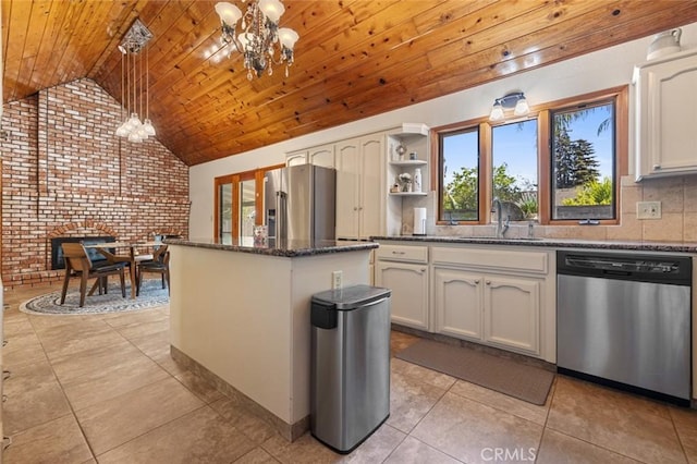 2604 Veneman Ave, Modesto, CA 95356 - kitchen with stainless steel appliances, a sink, a chandelier, brick wall, and healthy amount of natural light