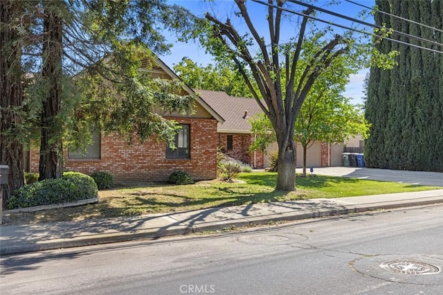 2604 Veneman Ave, Modesto, CA 95356 - view of front facade with brick siding, driveway, and a front lawn