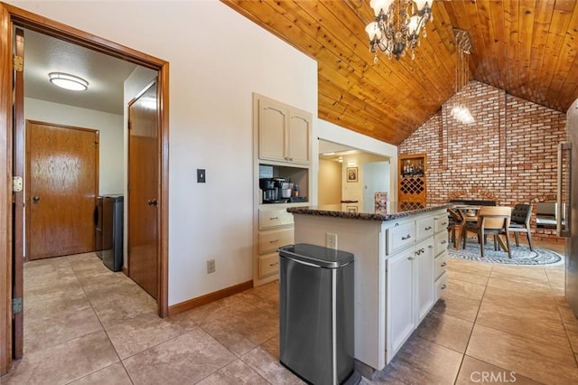 2604 Veneman Ave, Modesto, CA 95356 - kitchen featuring brick wall, light tile patterned flooring, lofted ceiling, a center island, and wood ceiling