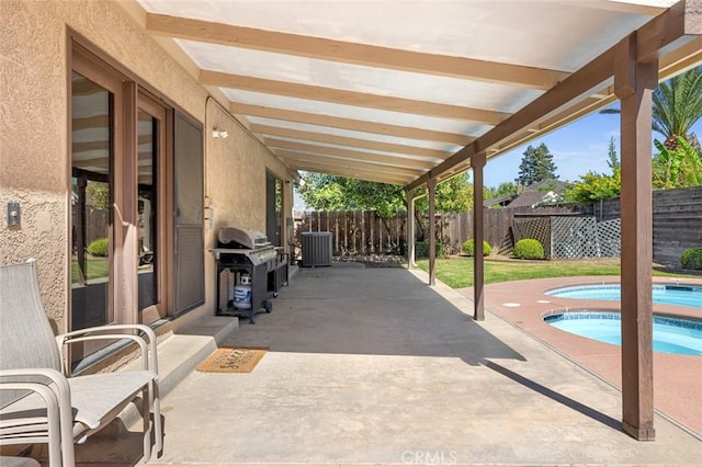 2604 Veneman Ave, Modesto, CA 95356 - view of patio with a grill, a fenced backyard, and central AC