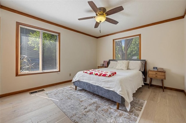 2604 Veneman Ave, Modesto, CA 95356 - bedroom with multiple windows, crown molding, baseboards, light wood-type flooring, and a ceiling fan