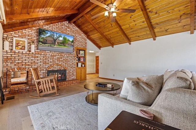 2604 Veneman Ave, Modesto, CA 95356 - living room with wood ceiling, hardwood / wood-style floors, a fireplace, a ceiling fan, and beam ceiling