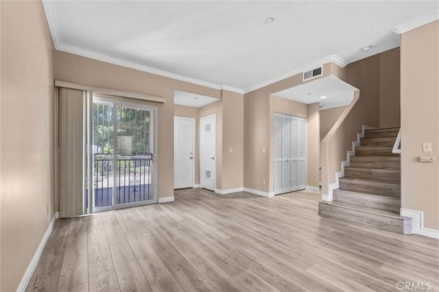 unfurnished living room with wood finished floors, baseboards, stairway, and ornamental molding