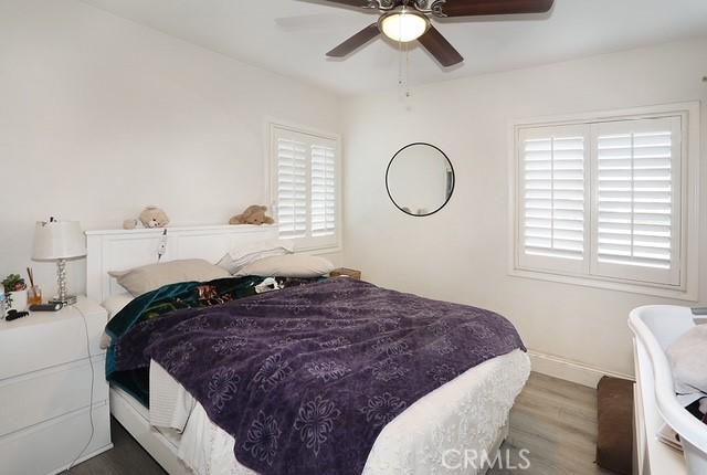 885 N Millard Ave, Rialto, CA 92376 - bedroom featuring wood finished floors, baseboards, and a ceiling fan