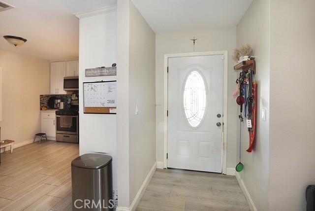 885 N Millard Ave, Rialto, CA 92376 - entrance foyer featuring light wood finished floors and baseboards