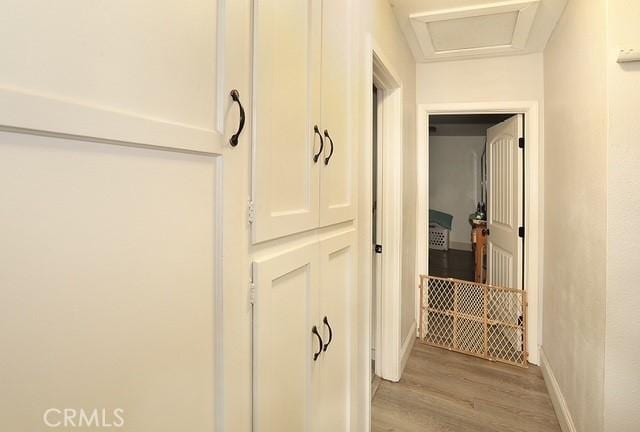 885 N Millard Ave, Rialto, CA 92376 - hall with light wood-type flooring, attic access, and baseboards