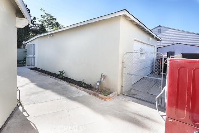 885 N Millard Ave, Rialto, CA 92376 - view of side of property featuring stucco siding and a gate