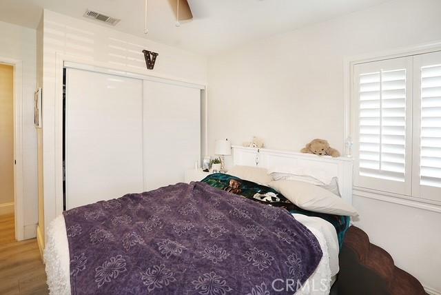 885 N Millard Ave, Rialto, CA 92376 - bedroom featuring wood finished floors, a closet, and a ceiling fan