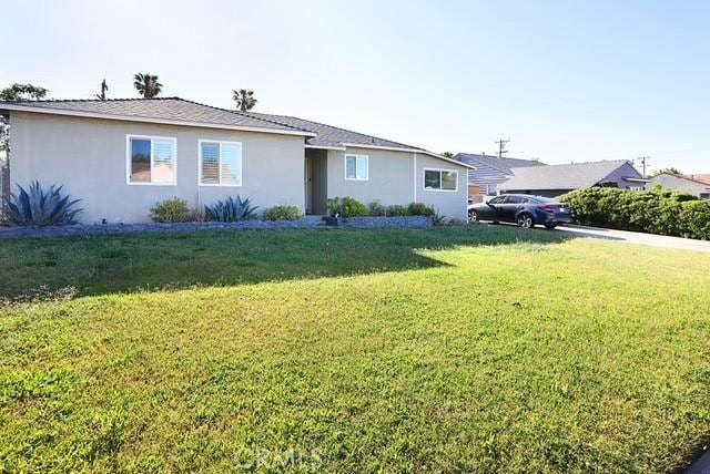 885 N Millard Ave, Rialto, CA 92376 - ranch-style home with a front lawn and stucco siding