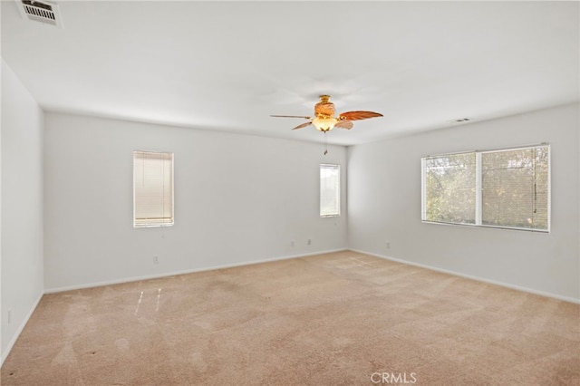 unfurnished room featuring light carpet, ceiling fan, and baseboards