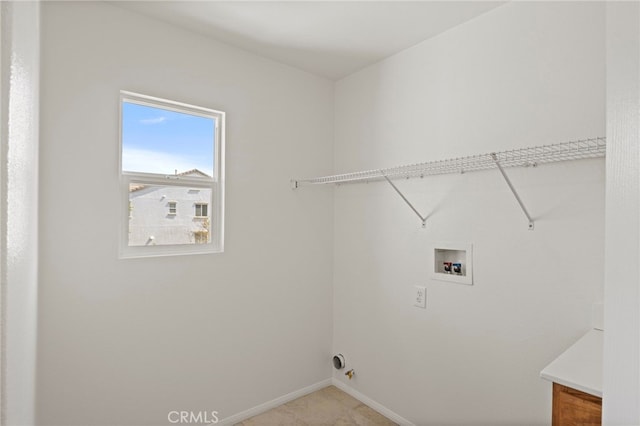 clothes washing area featuring washer hookup and baseboards