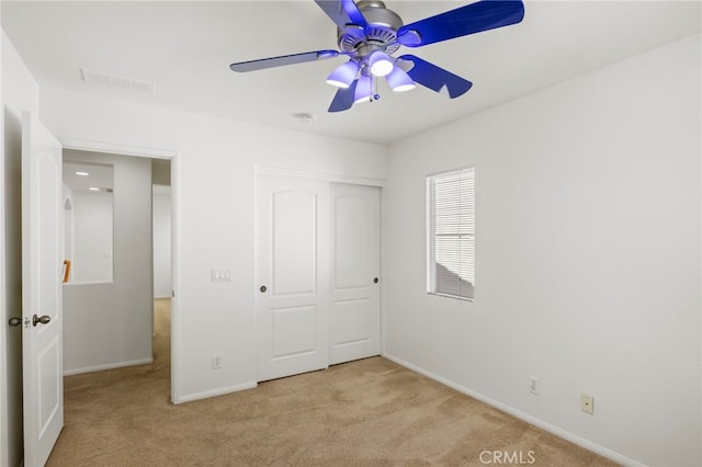 unfurnished bedroom featuring carpet flooring, baseboards, and a closet
