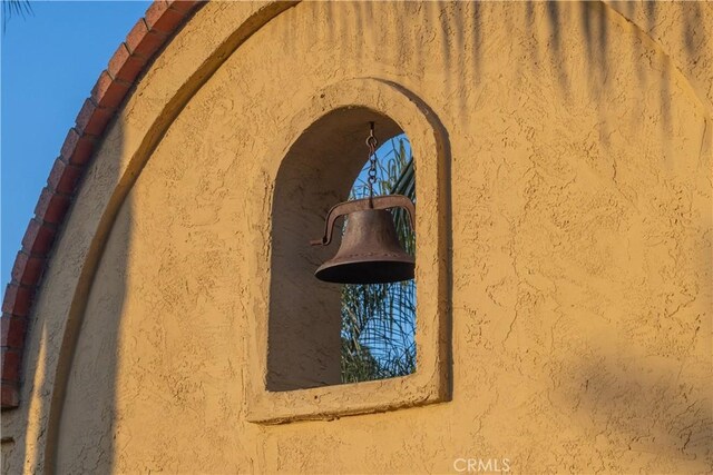 exterior view of stucco siding and arched walkways