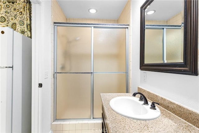 full bathroom featuring a shower stall, vanity, and recessed lighting