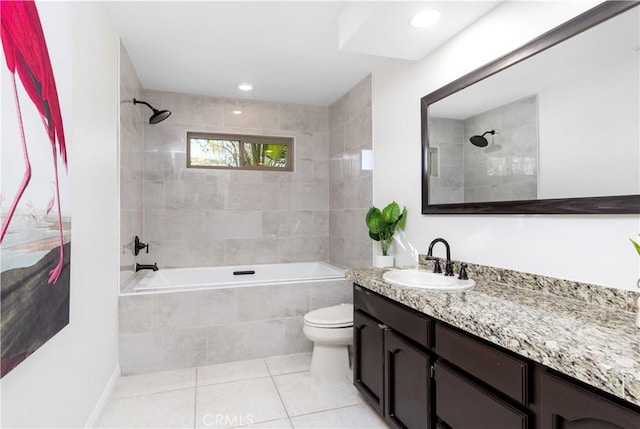 full bathroom featuring tile patterned flooring, tiled shower / bath, vanity, and toilet