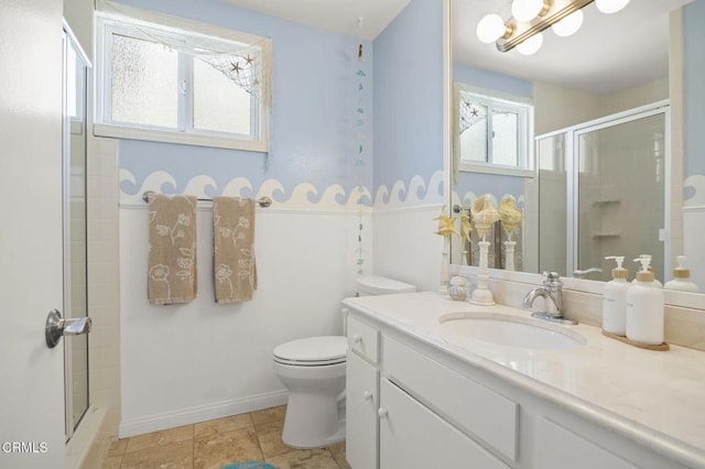 325 Ocean Dr, Oxnard, CA 93035 - full bathroom with a stall shower, toilet, vanity, and wainscoting