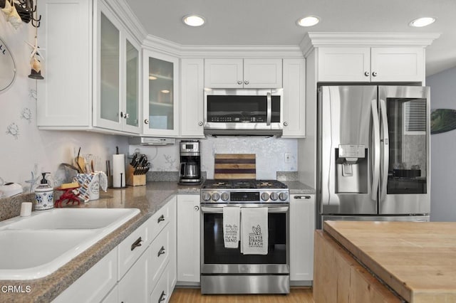 325 Ocean Dr, Oxnard, CA 93035 - kitchen featuring stainless steel appliances, white cabinets, a sink, butcher block counters, and recessed lighting