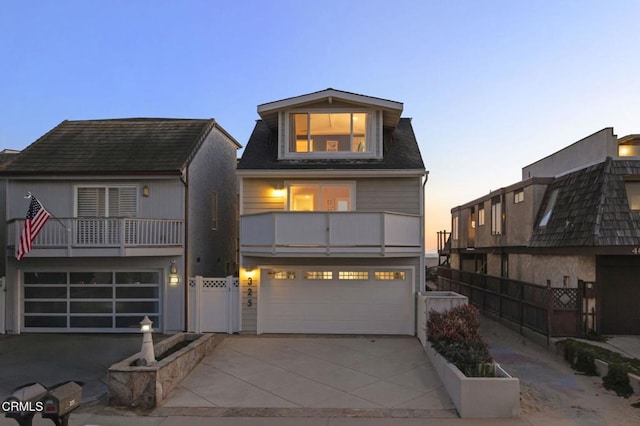 325 Ocean Dr, Oxnard, CA 93035 - view of front of property with an attached garage, a balcony, fence, and concrete driveway