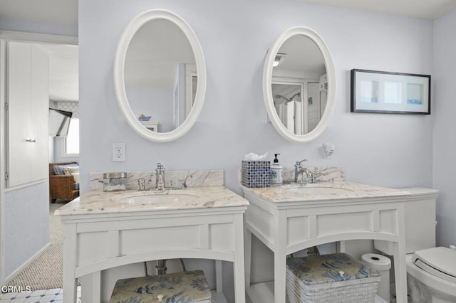 325 Ocean Dr, Oxnard, CA 93035 - full bath featuring two vanities, toilet, and connected bathroom