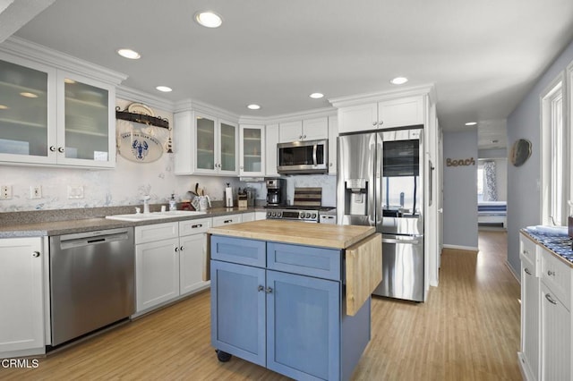 325 Ocean Dr, Oxnard, CA 93035 - kitchen featuring stainless steel appliances, butcher block counters, a sink, white cabinetry, and recessed lighting