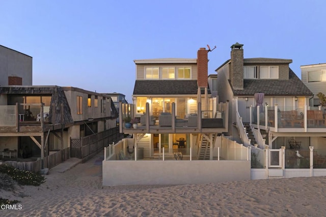325 Ocean Dr, Oxnard, CA 93035 - back of house with stairway, a chimney, a deck, and fence