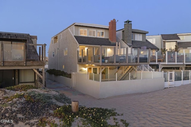 325 Ocean Dr, Oxnard, CA 93035 - rear view of house with stairway, a chimney, a wooden deck, and fence