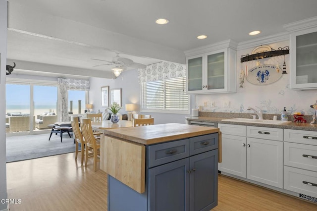 325 Ocean Dr, Oxnard, CA 93035 - kitchen featuring wood counters, a sink, white cabinets, light wood-style floors, and recessed lighting