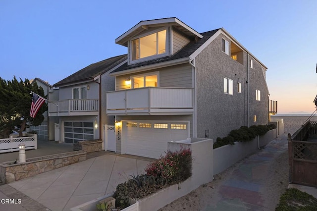 325 Ocean Dr, Oxnard, CA 93035 - view of front of house featuring a garage, a balcony, driveway, and fence