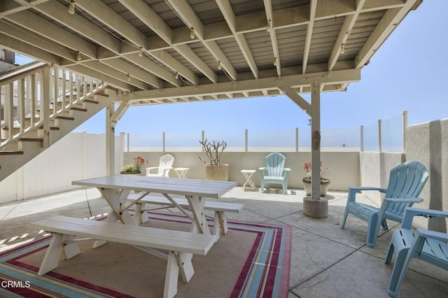 325 Ocean Dr, Oxnard, CA 93035 - view of patio / terrace with stairs, outdoor dining space, and fence