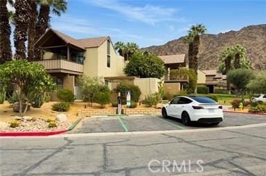 78130 Cortez Ln Unit 53, Indian Wells, CA 92210 - view of building exterior featuring a mountain view and uncovered parking