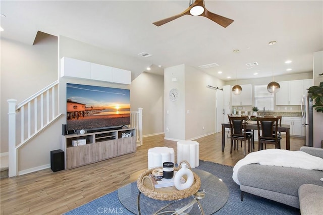 2651 W Lincoln Ave Unit 40, Anaheim, CA 92801 - living area with light wood finished floors, a ceiling fan, recessed lighting, stairway, and baseboards