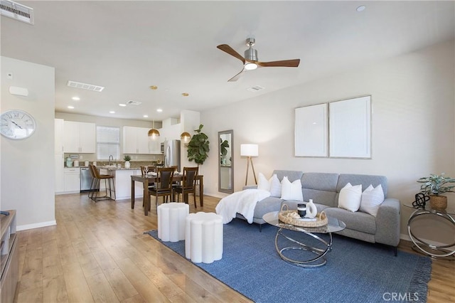 2651 W Lincoln Ave Unit 40, Anaheim, CA 92801 - living room with light wood-type flooring, ceiling fan, and recessed lighting