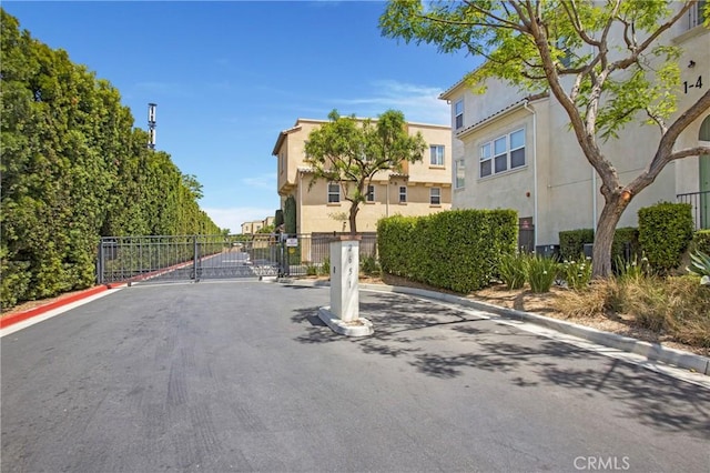 2651 W Lincoln Ave Unit 40, Anaheim, CA 92801 - view of asphalt street featuring a gate, curbs, and a gated entry
