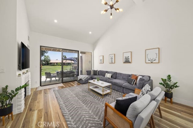 living room with high vaulted ceiling, a chandelier, wood finished floors, and recessed lighting