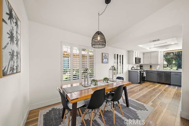 dining room featuring light wood-style floors and baseboards